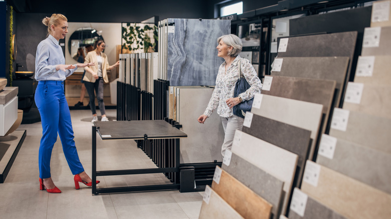 Sales woman greeting a customer in a tile show room