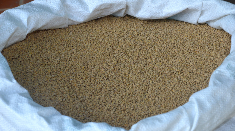 Closeup of alfalfa meal in a white bag