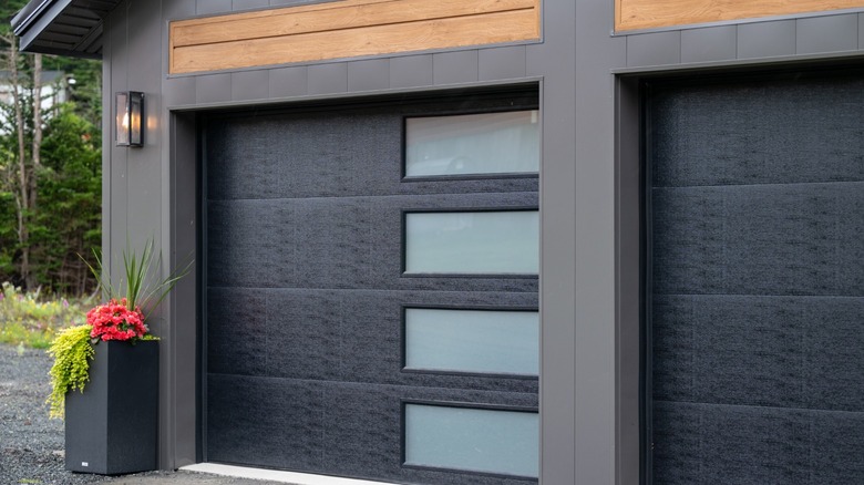 Modern black garage door with windows