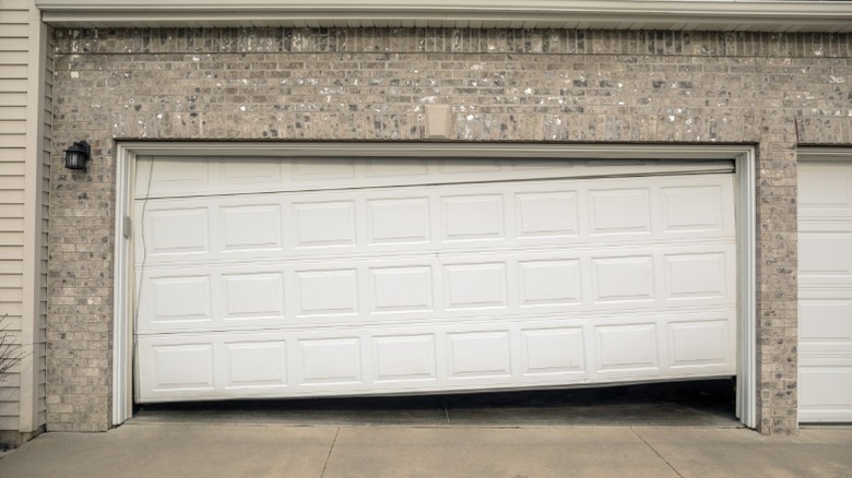 Visibly broken and misaligned garage door
