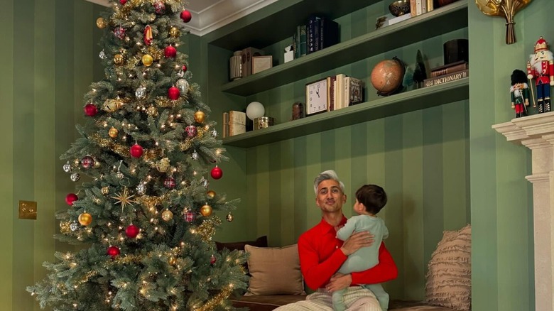 Tan France in front of his tree