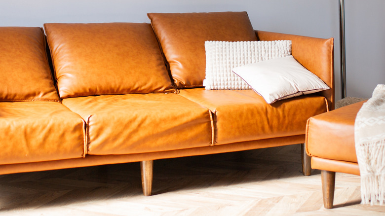 Faux leather sofa with cushions