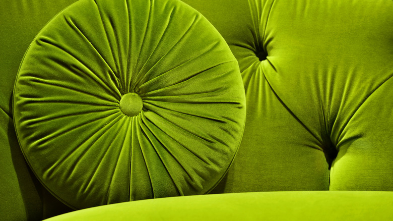 Green velvet couch and cushion
