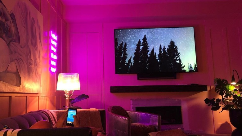 Neon pink walls in a dimly lit living room