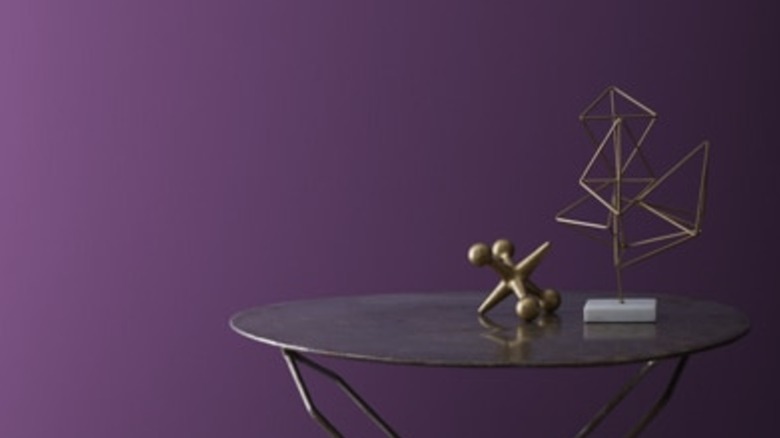 Dark purple painted walls behind table