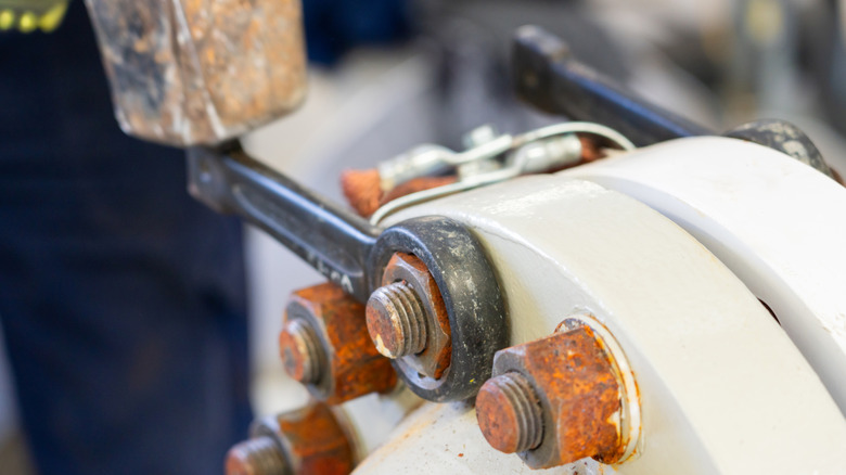 improper use of a hammer on a flange while removing a rusted bolt