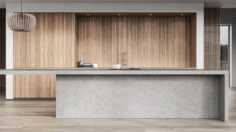 Modern kitchen with a concrete countertop and wooden accents