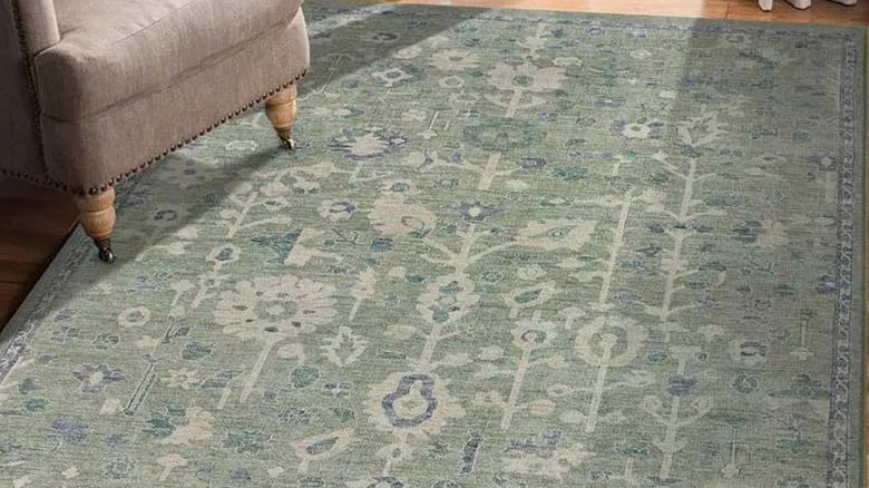 Green floral medallion At Home rug in a living room