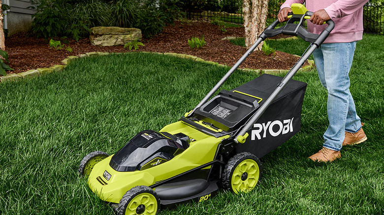 Man mowing lawn with Ryobi 40V Hp Brushless 20" Self-Propelled Multi-Blade Mower Kit