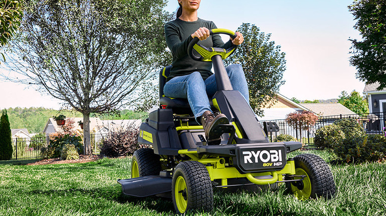 Women mowing lawn on a Ryobi 30" riding lawn mower