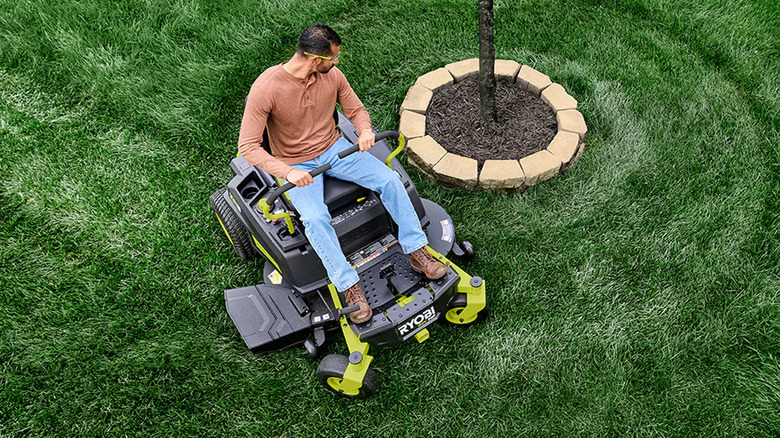 Man mowing lawn on a Ryobi 42" Zero Turn Riding Lawn Mower