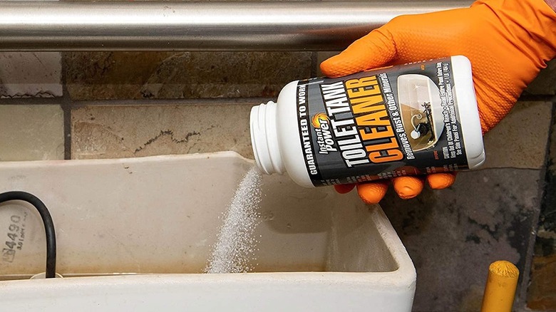 Instant Power Toilet Tank cleaner being poured into the tank.