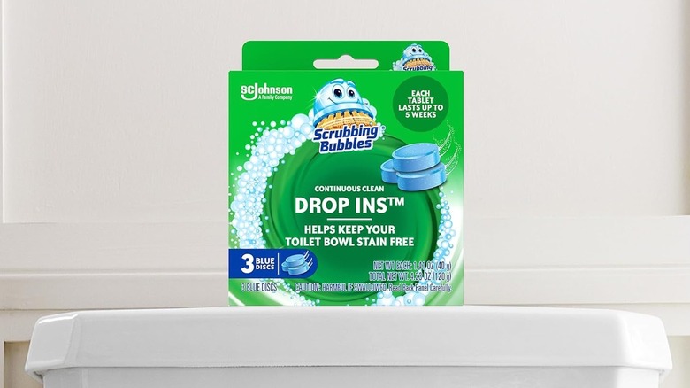 A pack of Scrubbing Bubbles Toilet Tablets sitting on top of a toilet.