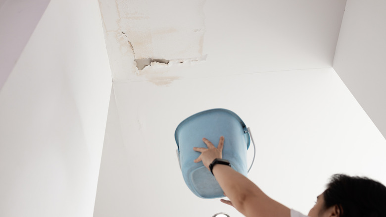 Peeling paint on an interior ceiling due to a leaking roof