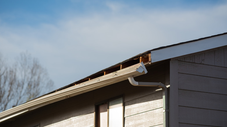 loose gutter hanging from roof