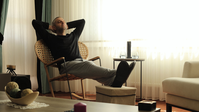 A man leaning back, looking relaxed in a chair