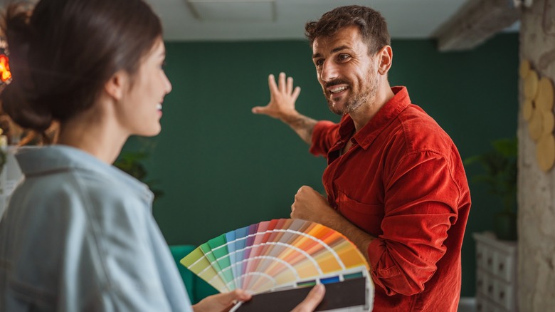 A couple looking at color swatches in their home