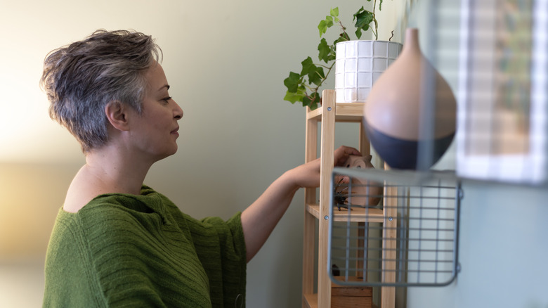 A woman looks at decor in a home