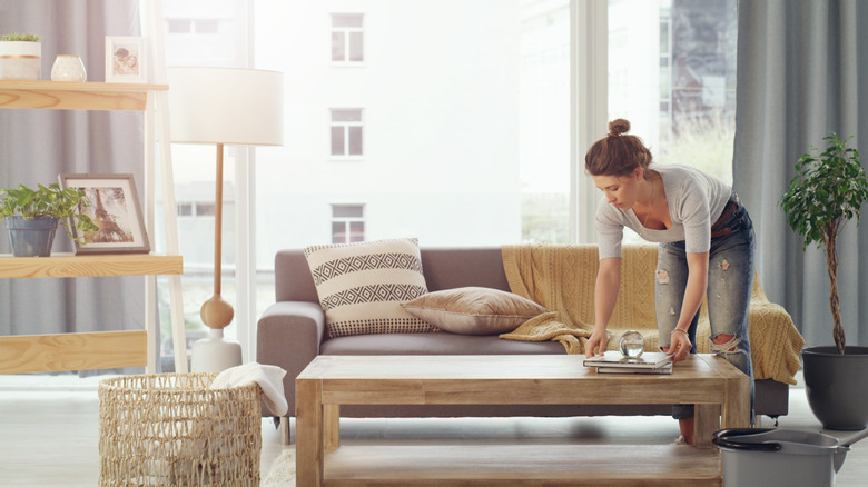 A young woman cleaning her home