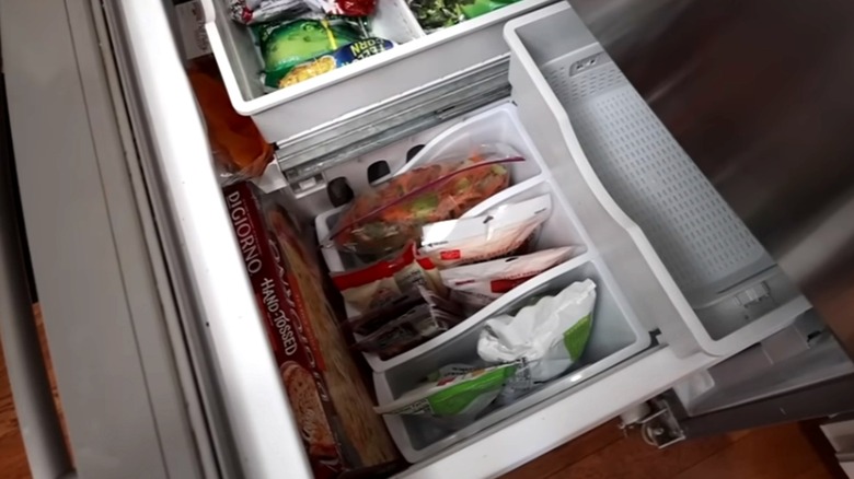 Dollar Tree book bins filled with frozen veggie bags in a freezer drawer
