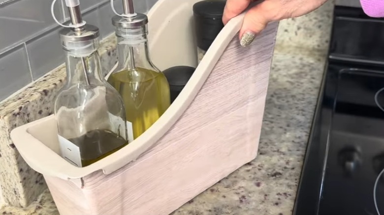 dollar tree bin holding spices and oils on kitchen counter