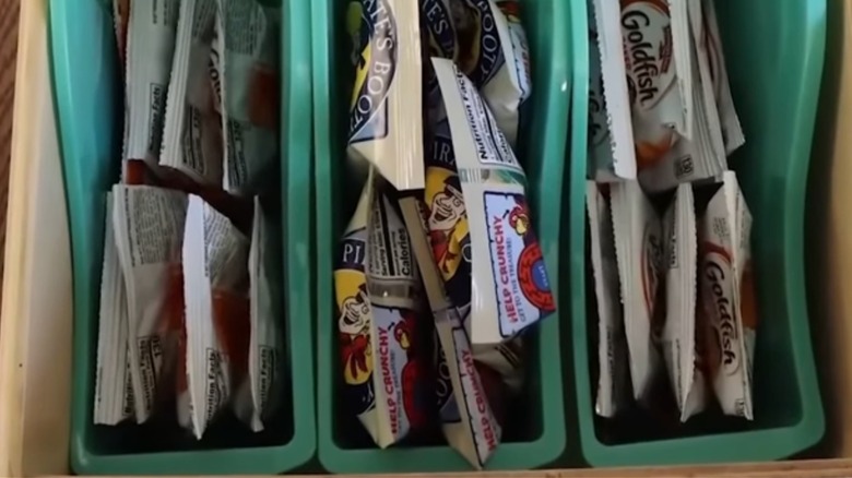 Lined up book bins holding snack bags