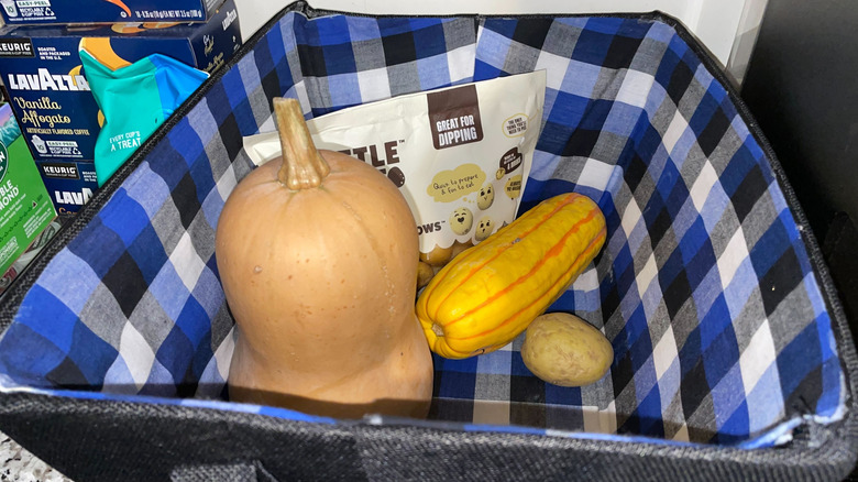 Potatoes and squash in a fabric storage bin