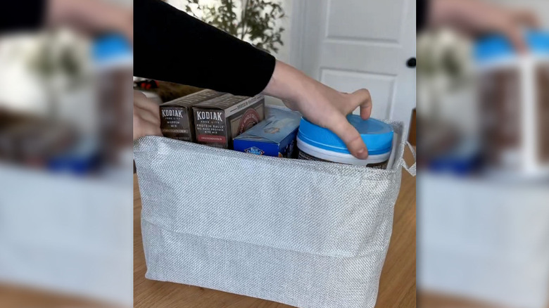 Boxed food products in a fabric bin with a plastic bin liner