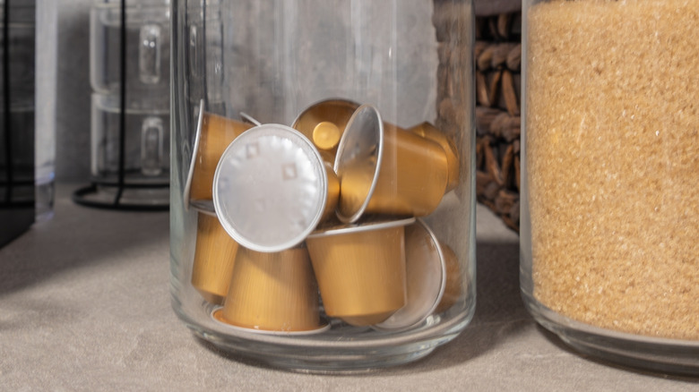 Coffee pods in a glass jar on counter