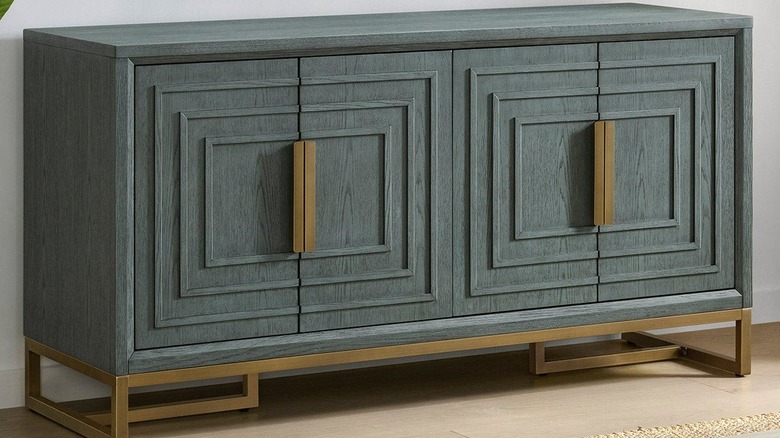 Art deco inspired green media console with brass accents