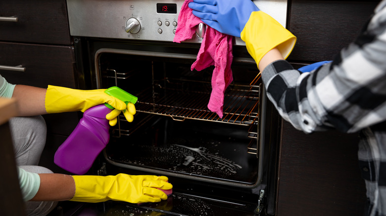 cleaning hands spray down oven