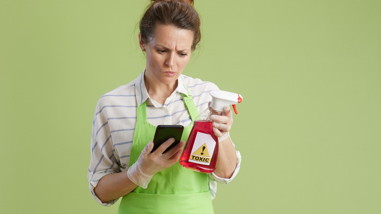 woman determining whether cleaning product is toxic
