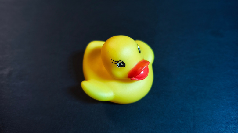 Close up of rubber duck toy on black background