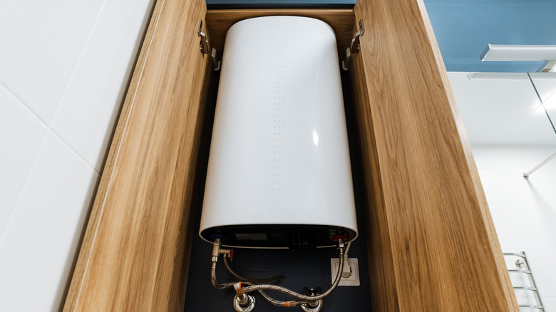A water heater tucked away in an open cabinet