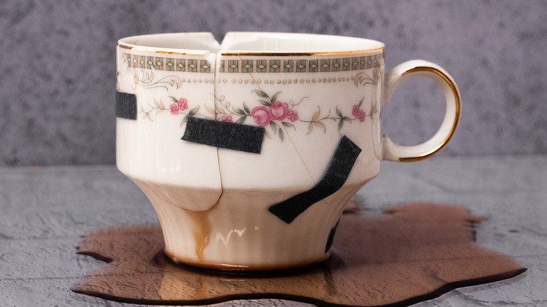 Close up of a broken teacup taped together