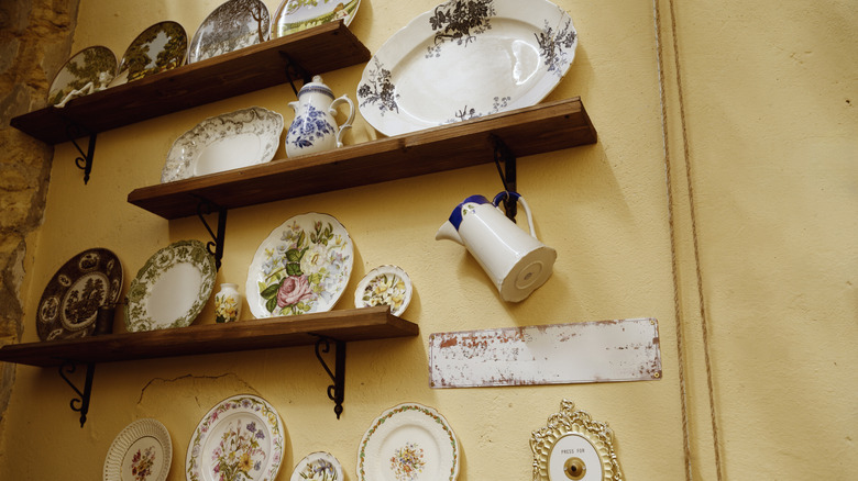 Close up of porcelain items stored on wall shelves