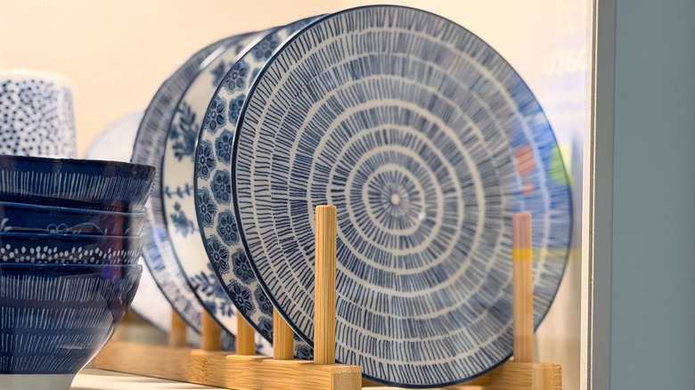 Close up of porcelain plates stored in plate holder