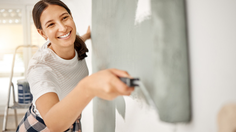 Woman painting a wall