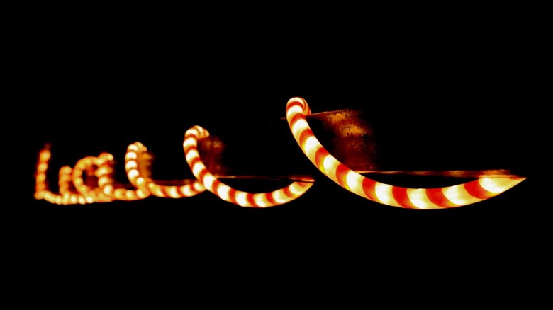 Red and white rope lights wrapped around a bar