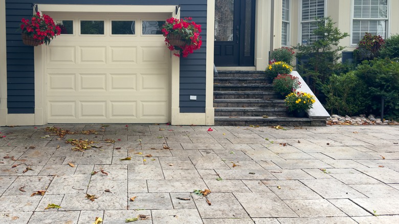 A blue house with stamped driveway