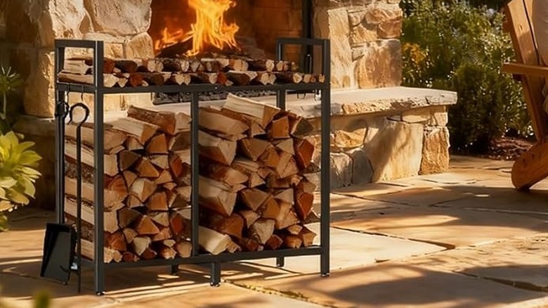 A fire rack station with tools hanging on hooks and a top shelf for kindling.