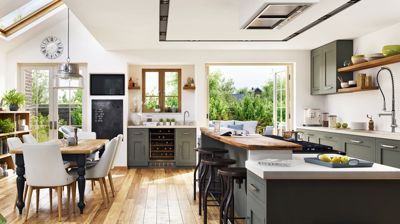 A modern farmhouse style open-concept kitchen with French doors that open to the backyard.