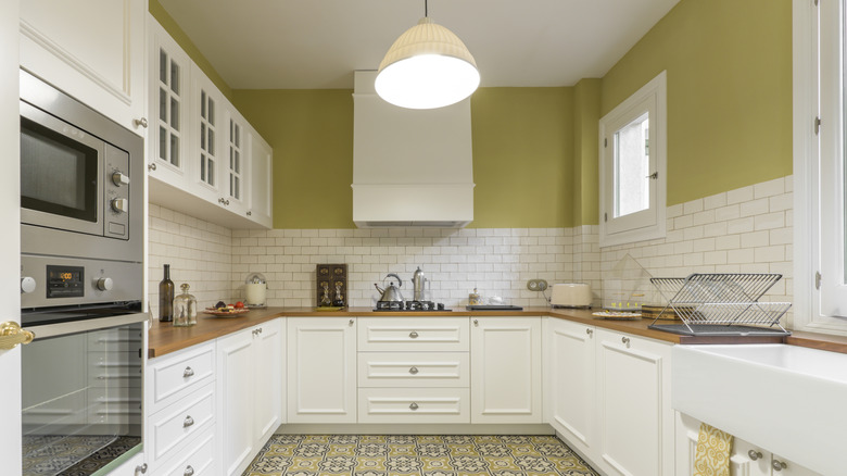 A white and lime green U-shaped kitchen layout with a modern farmhouse vibe.