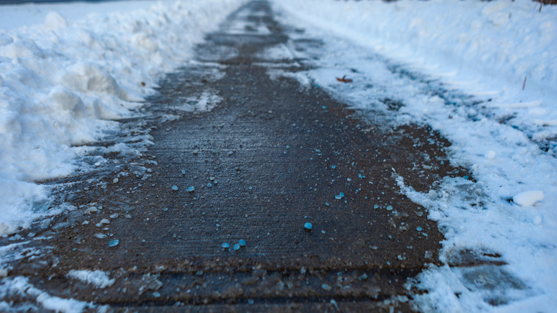 blue Magnesium chloride on a snowy sidewalk