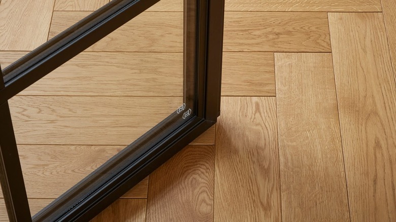 A warm honey hardwood floor under a door
