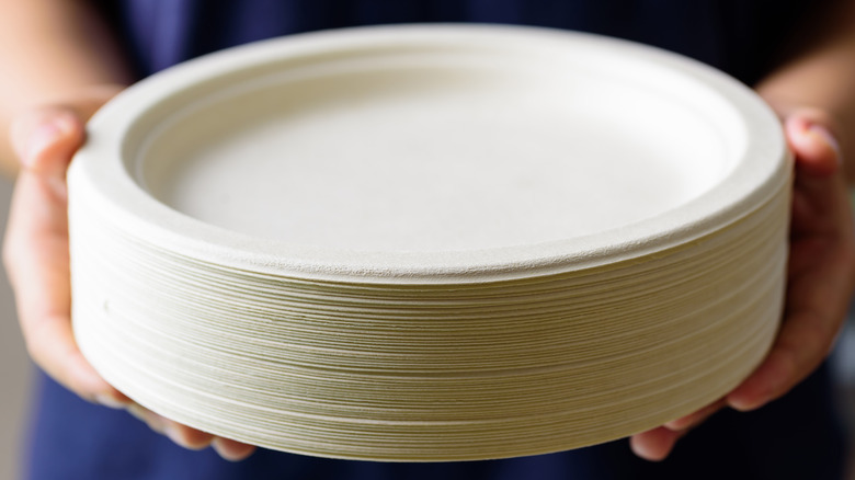 Hands holding paper plates