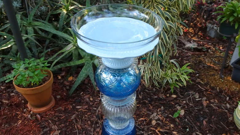 Bird bath made of glass items from the thrift store