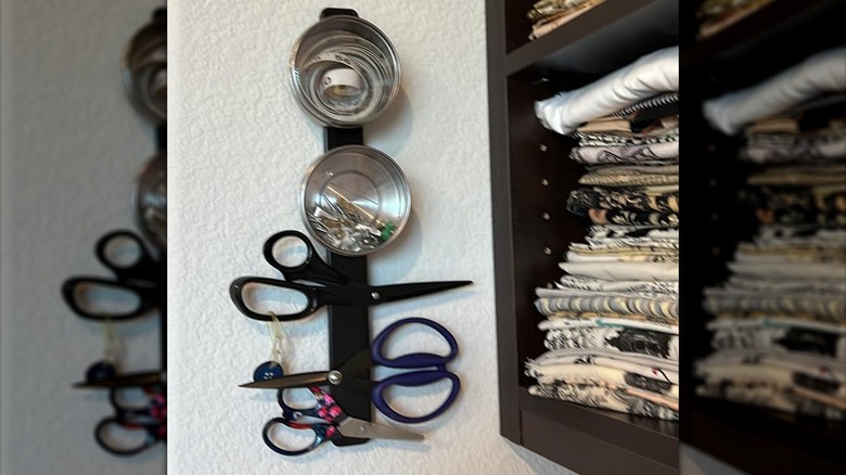 Metal canister and scissors sticking to magnetic knife rail