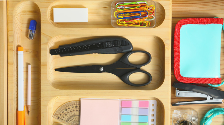 Stationery neatly organized in drawer divider trays