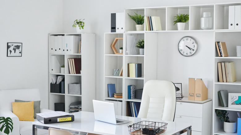 A clean home office with open shelved cabinets